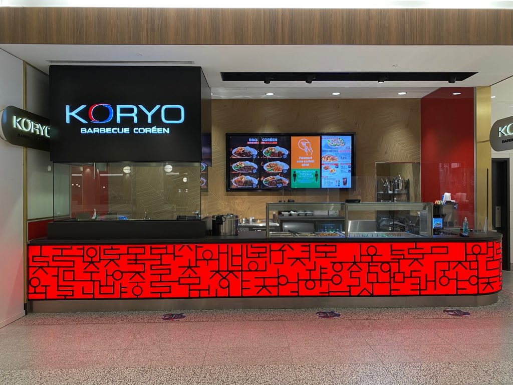 Koryo Barbecue restaurant interior with menu screens and vibrant decor