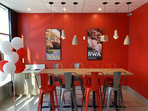 Brand-new restaurant with modern design lamps and red and gray chairs | MTY Group Franchising Q&A: Your Questions Answered Blog